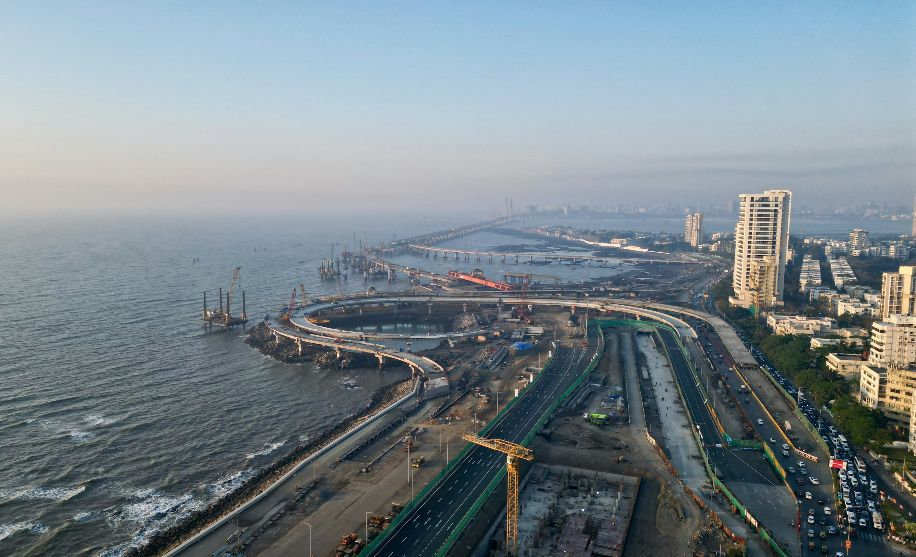 Aerial view of Mumbai's Coastal Road at Worli, with the Sea Link in the distance